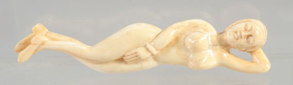 A DOCTOR'S CARVED BONE NUDE FIGURE. 4.75ins long.