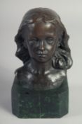 A SMALL BRONZE BUST OF A GIRL on a marble base. 5ins high.