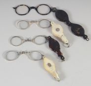 FOUR MOTHER OF PEARL FOLDING MAGNIFYING GLASSES.