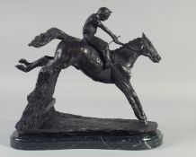 A FINE BRONZE GROUP, HORSE AND JOCKEY OVER THE FENCE, on a marble base. 12ins high.