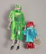 A SILVER ENAMEL PADDINGTON BEAR AND QUEEN BROOCH.