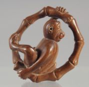 A CARVED WOOD NETSUKE, MONKEY 1.5ins, signed.
