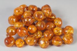 A GOOD SMALL AMBER BEAD NECKLACE of large beads, 32 beads, 24ins long. 80gms.
