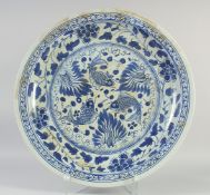 A LARGE CHINESE BLUE AND WHITE PORCELAIN FISH CHARGER. 24ins diameter.