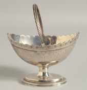 A GEORGE III SILVER BOAT SHAPE SUGAR BASKET, chased body and swing handle. London 1790. Maker C. H.