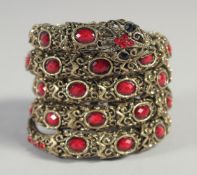 A LONG SILVER SNAKE BRACELET set with various coloured stones.