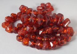A GOOD AMBER GRADUATED FACETED NECKLACE, 84 beads, 25ins long, with gold ring 32gms.