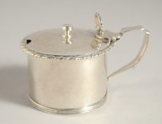 A GEORGE IV SILVER CIRCULAR MUSTARD POT with a sapphire blue liner. London 1828.