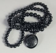 A LONG VICTORIAN JET NECKLACE AND PENDANT. 34ins long, 100gms.