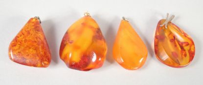 FOUR VARIOUS AMBER PENDANTS.. 42gms.