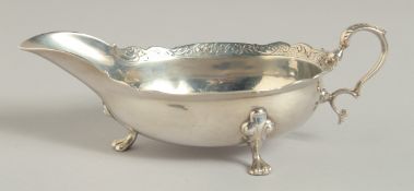A GEORGE II SCOTTISH SILVER SAUCEBOAT with shaped chased border. Edinburgh 1743. Maker: Robert