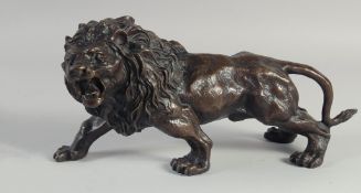 A BRONZE SNARLING LION. 12ins long.