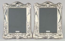 A PAIR OF ART NOUVEAU SILVER AND ENAMEL PHOTOGRAPH FRAMES 7.5ins x 6ins