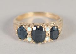 A 9CT GOLD, RUBY AND OPAL RING.
