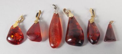 SIX VARIOUS AMBER PENDANTS, 15gms.