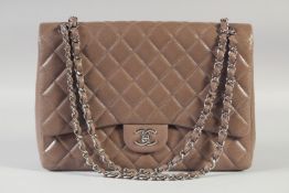 A LARGE CHANEL PADDED TAN-BROWN HAND BAG with chrome double C. 33cm long, 24cm high with long chrome