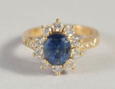AN 18CT YELLOW GOLD SAPPHIRE AND DIAMOND CLUSTER RING.