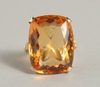 A YELLOW GOLD LARGE TOPAZ AND DIAMOND RING.
