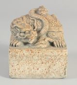 A CHINESE CARVED STONE SQUARE DRAGON SEAL. 3.75ins