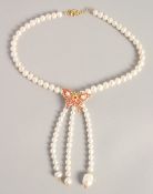 A PEARL NECKLACE with GOLD PLATED BUTTERFLY CLASP.