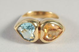AN 18CT YELLOW GOLD CITRINE AND AQUAMARINE DOUBLE HEART SHAPED RING.