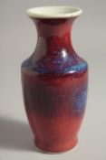A SMALL FLAMBE STYLE GLAZE PORCELAIN VASE. 15.5cm high.