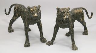 AN IMPRESSIVE, NEAR LIFE SIZE, PAIR OF BRONZE STANDING TIGERS, with gilded highlights. 3ft 8ins