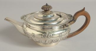 A VICTORIAN SILVER TEA POT AND COVER with gadrooned rims and scrolls to the body. London 1897.