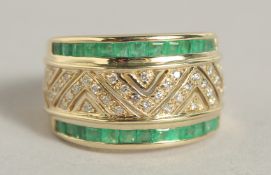 A 9CT YELLOW GOLD EMERALD AND DIAMOND BAND RING.