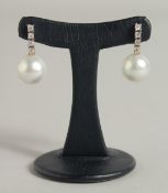 A PAIR OF SOUTH SEA PEARL AND DIAMOND EARRINGS.