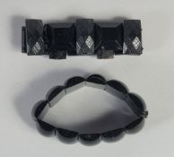 TWO WHITBY JET BRACELETS.