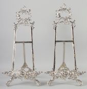 A PAIR OF SILVERED EASELS. 22ins long.