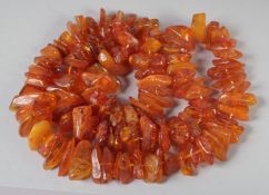 A GOOD FACETED AMBER BEAD NECKLACE, 100 beads, 30ins long, 122gms.