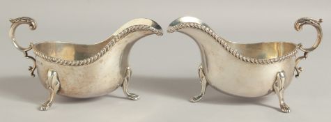 A PAIR OF HEAD SILVER SAUCEBOATS with gadrooned rim and three claw feet. Birmingham 1933. Maker: B B
