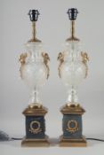 A PAIR OF GLASS AND ORMOLU URN SHAPED PEDESTAL TABLE LAMPS with swan handles. 2ft 1in high.