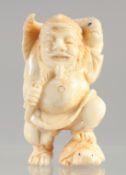 A CARVED BONE NETSUKE, FISHERMAN.