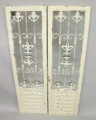A PAIR OF WHITE PAINTED MIRRORS with metal grill decoration. 4ft 11ins x 1ft 5ins.