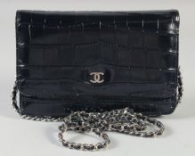 A SMALL CHANEL BLACK LEATHER BAG 18cm long, 12cm wide with long chrome and leather straps, 60cm