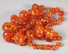A GOOD GRADUATED AMBER BEAD NECKLACE, 56 beads, 24ins long, 40gms.