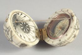 AN ETCHED BONE COMPASS. 1.5ins diameter.