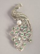 A SILVER EMERALD MARCASITE AND PEARL PEACOCK BROOCH.
