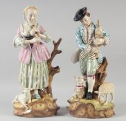 A LARGE PAIR OF CONTINENTAL PORCELAIN FIGURES OF A YOUNG MAN AND A YOUNG LADY with sheep at their