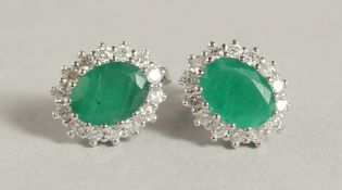 A PAIR OF 18CT WHITE GOLD EMERALD AND DIAMOND EARRINGS.