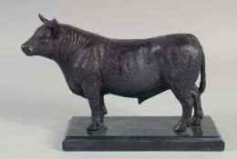 A GOOD BRONZE OF A BULL on a marble base. 9ins long.
