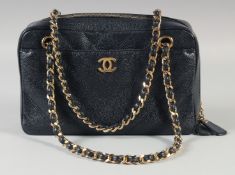 A GOOD CHANEL BLACK CROCODILE HAND BAG 25cm long, 15cm high with long gilt and leather double strap,