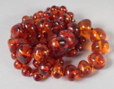A GOOD SMALL AMBER BEAD NECKLACE of graduated beads. 24ins long, 62 beads, 35gms.