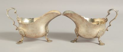 A GOOD PAIR OF GEORGE III DESIGN SILVER SAUCE BOATS on three shell and claw feet. Retailed by