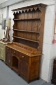 A good elm dresser with triple delft rack, six spice drawers, the base with three frieze drawers