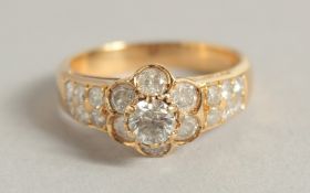 AN 18CT YELLOW GOLD DIAMOND CLUSTER RING. 1.5ct diamonds.