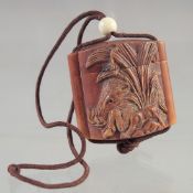 A SMALL CARVED WOOD INRO with rope.
